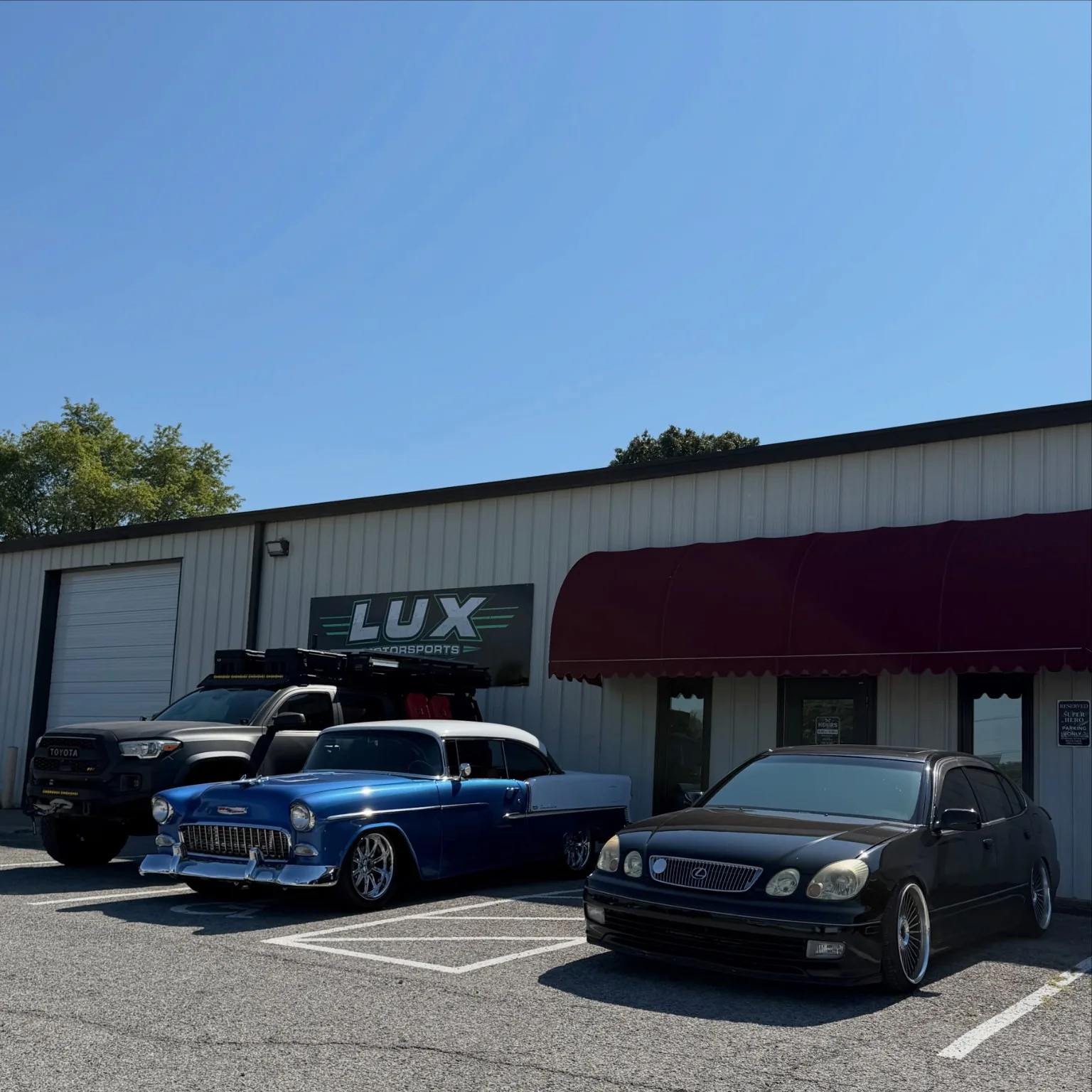 Classic blue Chevrolet displayed outside the shop