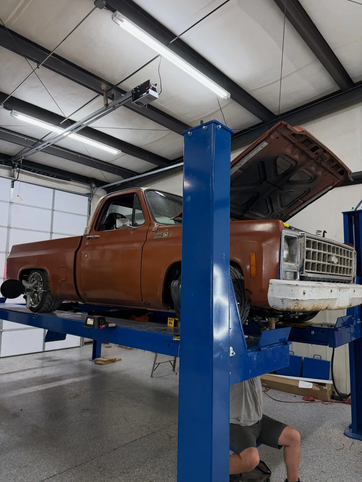 Vintage truck raised on a workshop lift