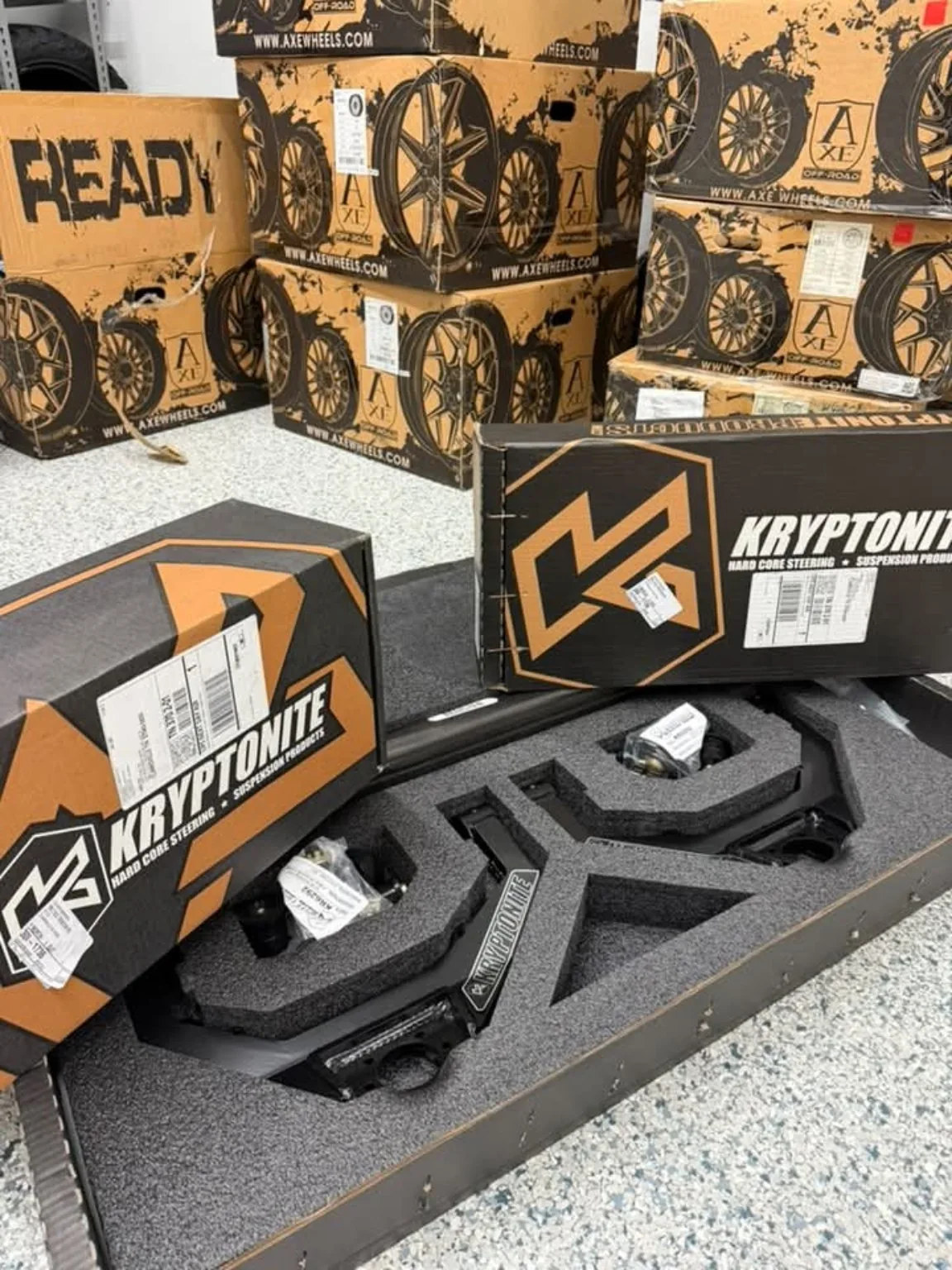 Aftermarket wheels and suspension components in the shop