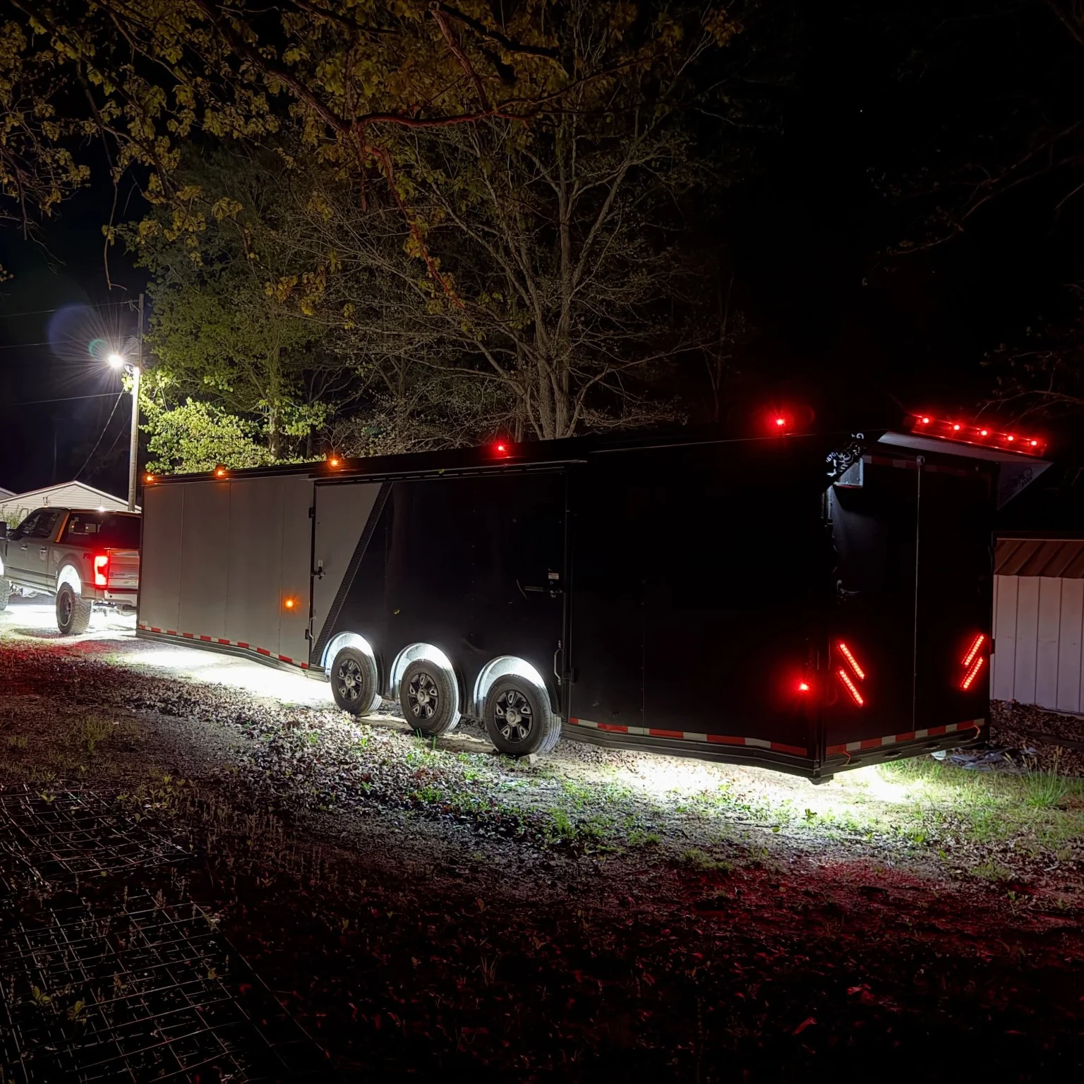 Enclosed trailer photographed from the rear with nighttime lighting